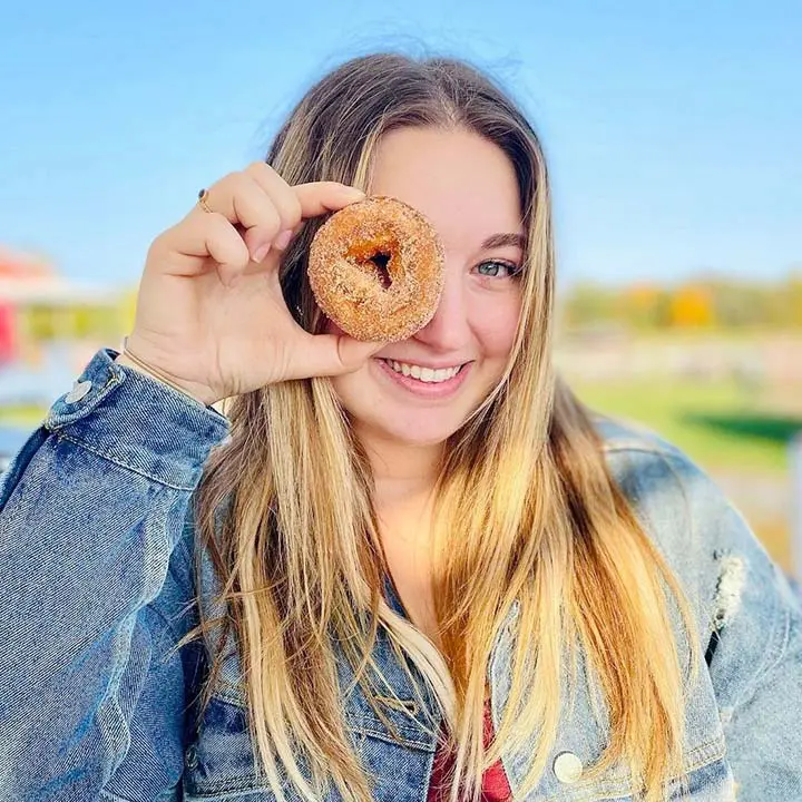 Girl holding donut up to eye